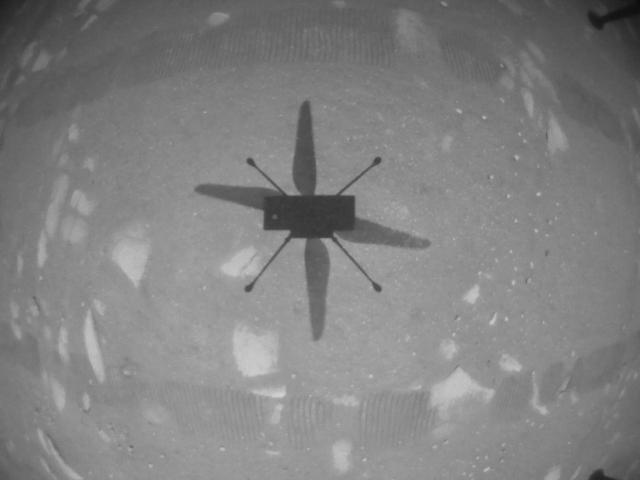 First flight of the Ingenuity Mars helicopter showing shadow on surface of Mars